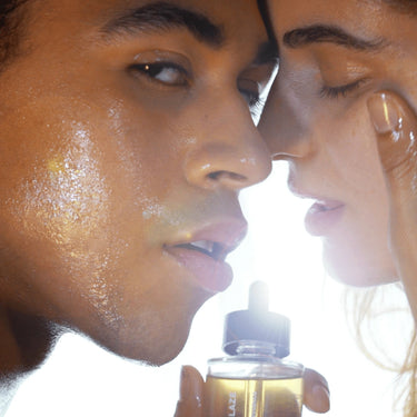 Ein Mann und eine Frau mit strahlender Haut, die das RADIANT GLAZE GESICHTSÖL von DALUMA für einen strahlenden Teint und gegen trockene Haut genießen.